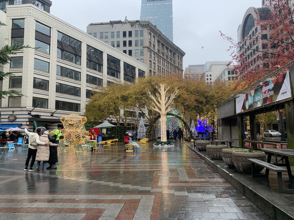 Empty tables and holidays lights in a plaza. 