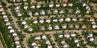 An aerial shot of cookie cutter houses in a subdivision.