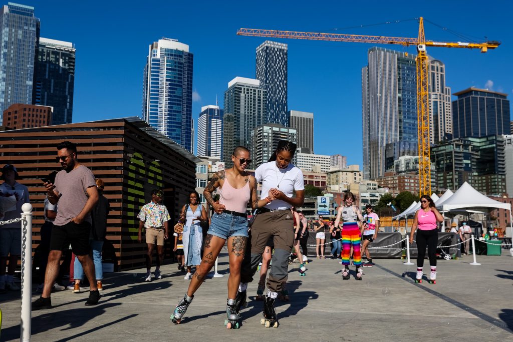 People roller skate on a pier. 