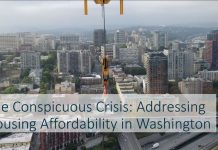 Housing Notes: Council Preserves Drive Thru, Challenge Seattle Report Backs Zoning Overhaul A photo shows the Seattle skyline viewed from First Hill from a new tower construction project.