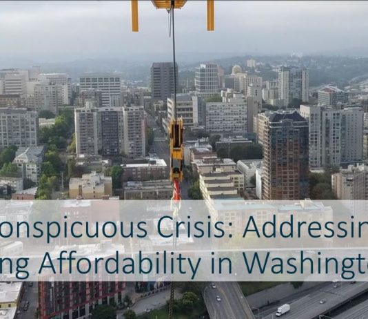 Housing Notes: Council Preserves Drive Thru, Challenge Seattle Report Backs Zoning Overhaul A photo shows the Seattle skyline viewed from First Hill from a new tower construction project.