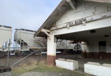 Leverage South Sound’s Freight Rail Network for Passenger Service A photo of the abandoned Steilacoom Rail Depot with a freight train behind it.