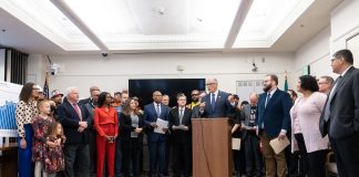 Governor Inslee stood at the podium at the Captiol with dozens of legislators and stakeholders behind him.