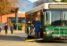 Week Without Driving Goes Nationwide This October – Join Us! A green bus marked Route 305 Sedro Woolley with its ramp out to let a woman with a cane exit.