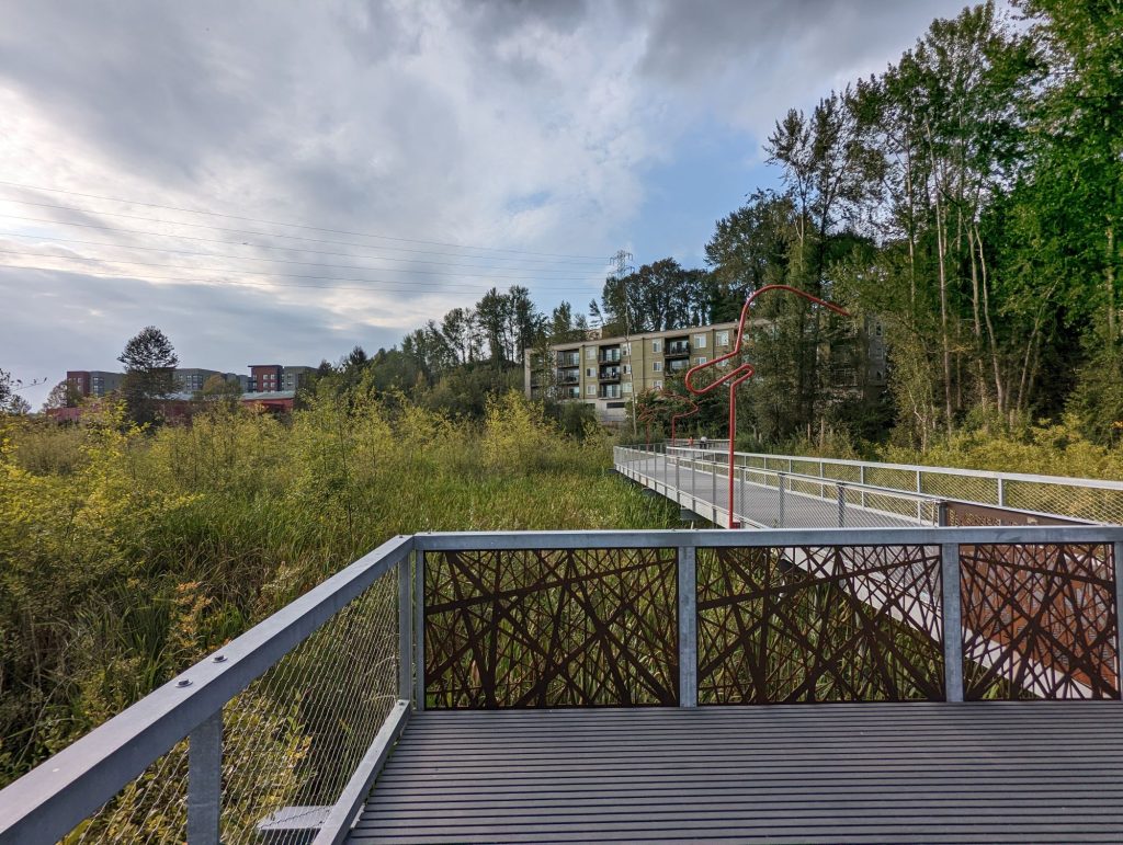 The totem lake park boardwalk facing The Village at Totem Lake