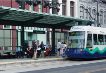 Tacoma Link’s Theater District Station Reaches the End of the Line A light rail train approaches a station where a string quartet plays.