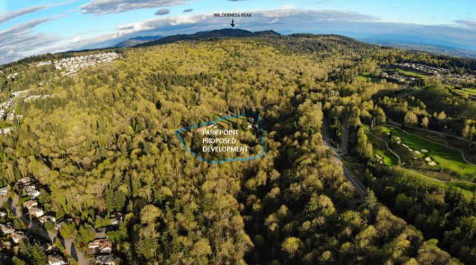 An aerial view of forested land with a circle indicating the 12 acres planned for single-family home development.