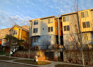 Micro-Apartments May Be Bellevue’s Next Affordability Move Microhousing building next to a single family home. Blue sky overhead and sunset lighting.