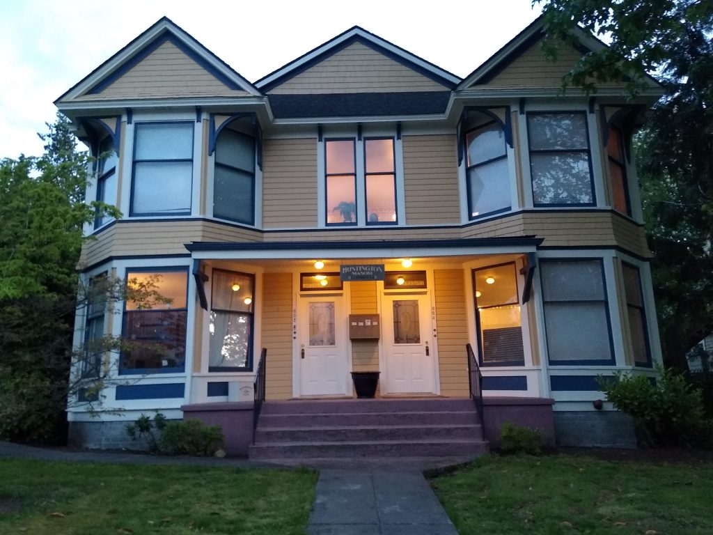 An apartment building that looks like a single family home, except for two front doors.