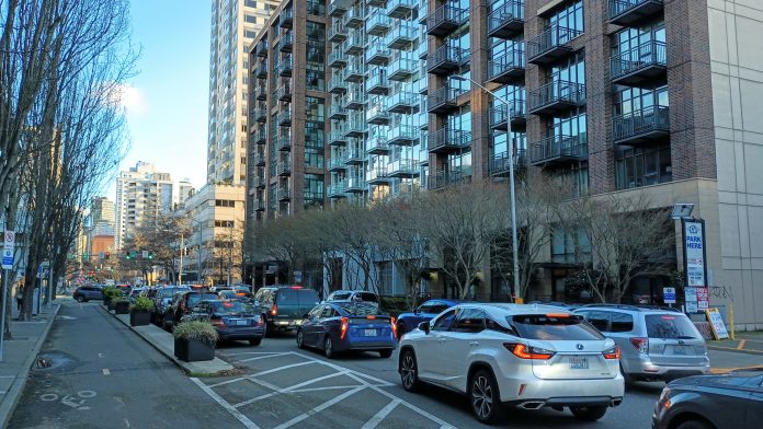 A backup of cars stretches from one end of the photo to the other