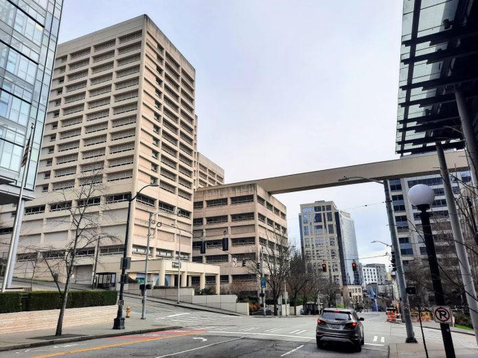 The view down 5th Avenue S with the King County Jail and skyway passage.