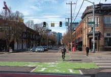 Legislature Abandons Most Traffic Safety Bills As Fatalities Continue To Mount Someone on a bike crosses the street as pedestrians walk in a crosswalk and drivers wait to turn at Broadway and Pike in Seattle