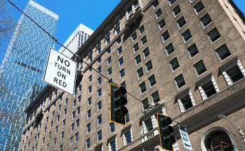 No Right Turn on Red Is Now the Default in Seattle A no turn on red sign in downtown Seattle with Rainier Tower building in the background