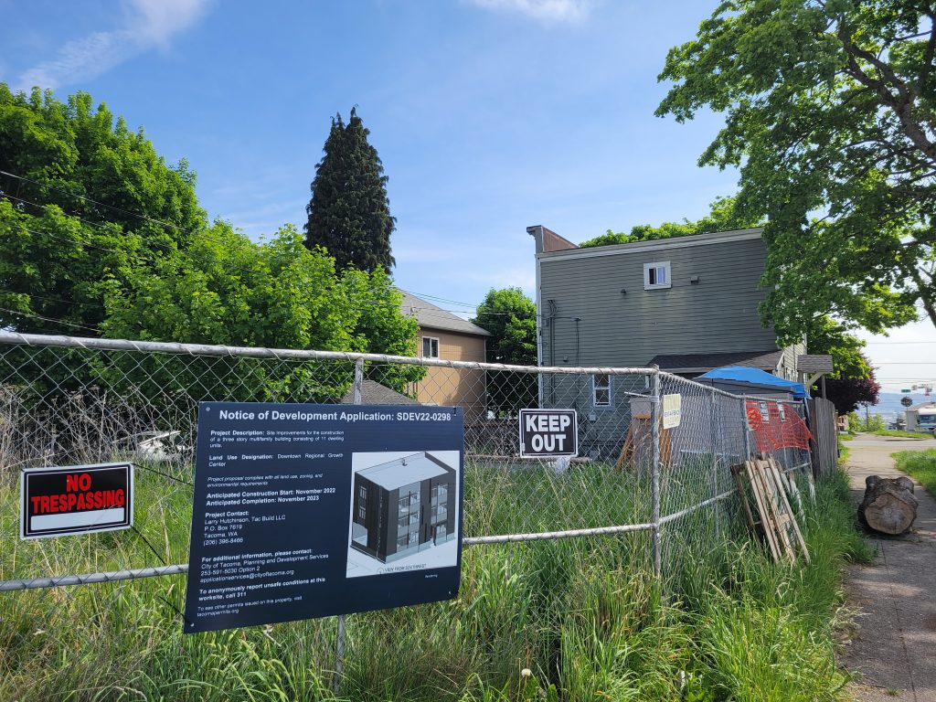 Chainlink fence with a notice of a new development to come.