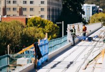 Board Worries Sound Transit Is Minimizing Role of Planned Megaproject Whiz Hires Midrise apartments arer in the background behind the elevated guideway in Redmond.