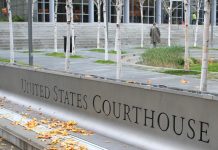 Seattle Is Suing Two Theft-Prone Automakers Using Public Nuisance Laws Sign for United States Courthouse, stairs and person walking to the entrance through skinny trees