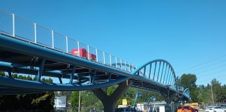 Construction equipment is visible on the pedestrian bridge over SR 520 in Totem Lake.