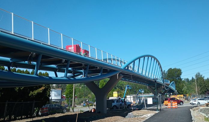 Construction equipment is visible on the pedestrian bridge over SR 520 in Totem Lake.