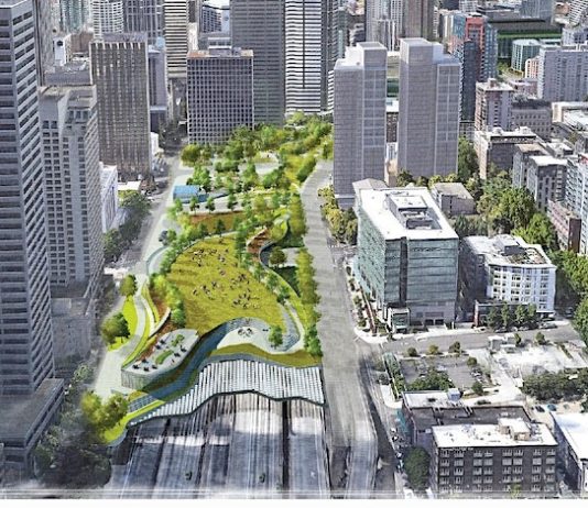 Seattle City Council Supports Lidding I-5 in New Resolution Aerial view of downtown buildings with rendering of a park lid over the highway.