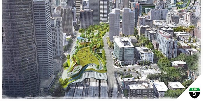 Aerial view of downtown buildings with rendering of a park lid over the highway.