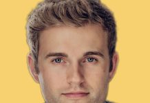 Ry Armstrong’s D3 Seattle Council Bid Stresses Shelter, Safety, and Sustainability Armstrong in a blazer. Yellow background behind.