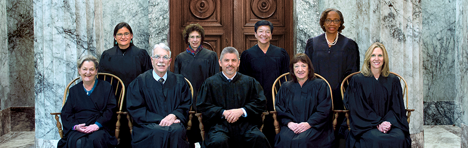 An official photo of the nine state Supreme Court justices in front of a marble columns. those justices are CHIEF JUSTICE STEVEN C. GONZÁLEZ ASSOCIATE CHIEF JUSTICE CHARLES W. JOHNSON Justice Barbara Madsen JUSTICE BARBARA A. MADSEN JUSTICE SUSAN OWENS JUSTICE DEBRA L. STEPHENS JUSTICE SHERYL GORDON McCLOUD JUSTICE MARY I. YU, JUSTICE RAQUEL MONTOYA-LEWIS and JUSTICE G. HELEN WHITENER