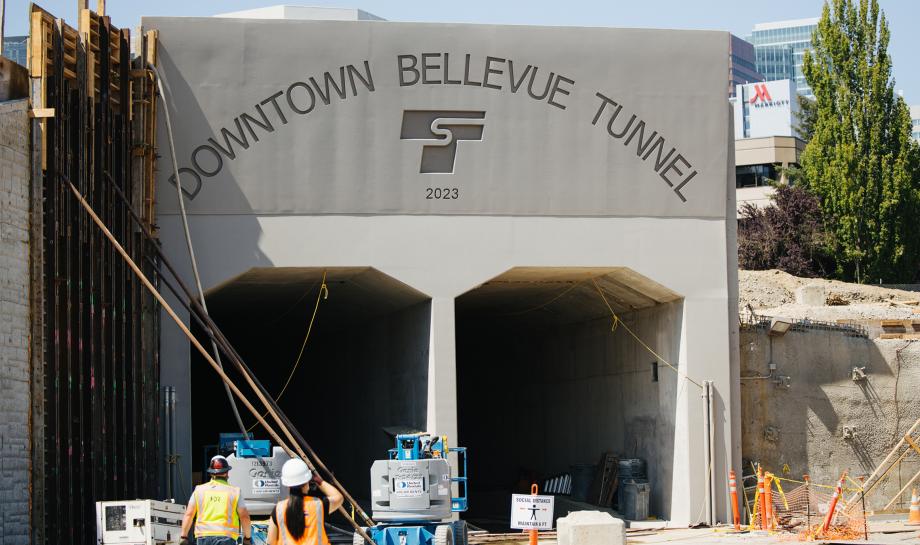 Bellevu's light rail tunnel portal with a construction worker in front.