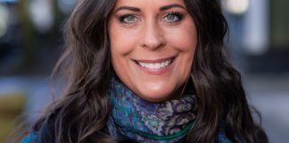 Maren is smiling and wearing a blue scarf.