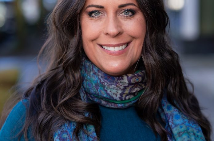 maren costa headshot Maren is smiling and wearing a blue scarf.