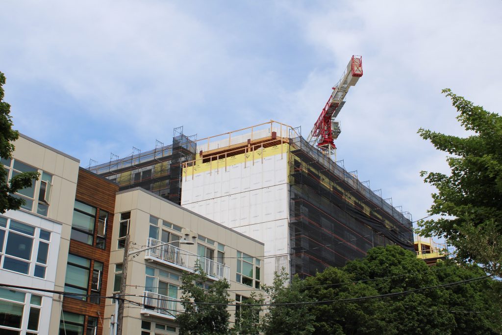 Crane over a multi-floor building under construction in the Fremont neighborhood of Seattle