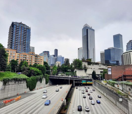 Americans Are Ready to Move On from Highway Expansion Even If Politicians Persist Seattle Skyline with I-5 trench and Freeway Park overhead.