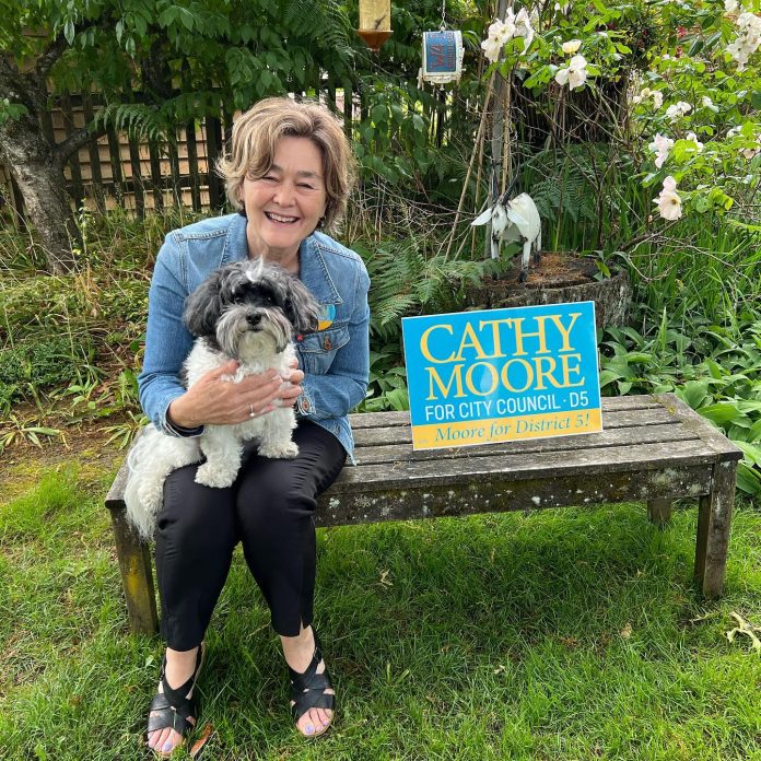 Cathy Moore with dog on bench via Facebook