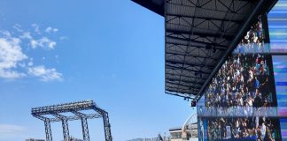 The outfield bleachers at T Mobile Park with the skyline and blue skies in the background.