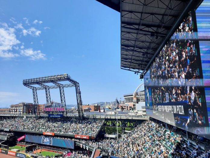 The outfield bleachers at T Mobile Park with the skyline and blue skies in the background.