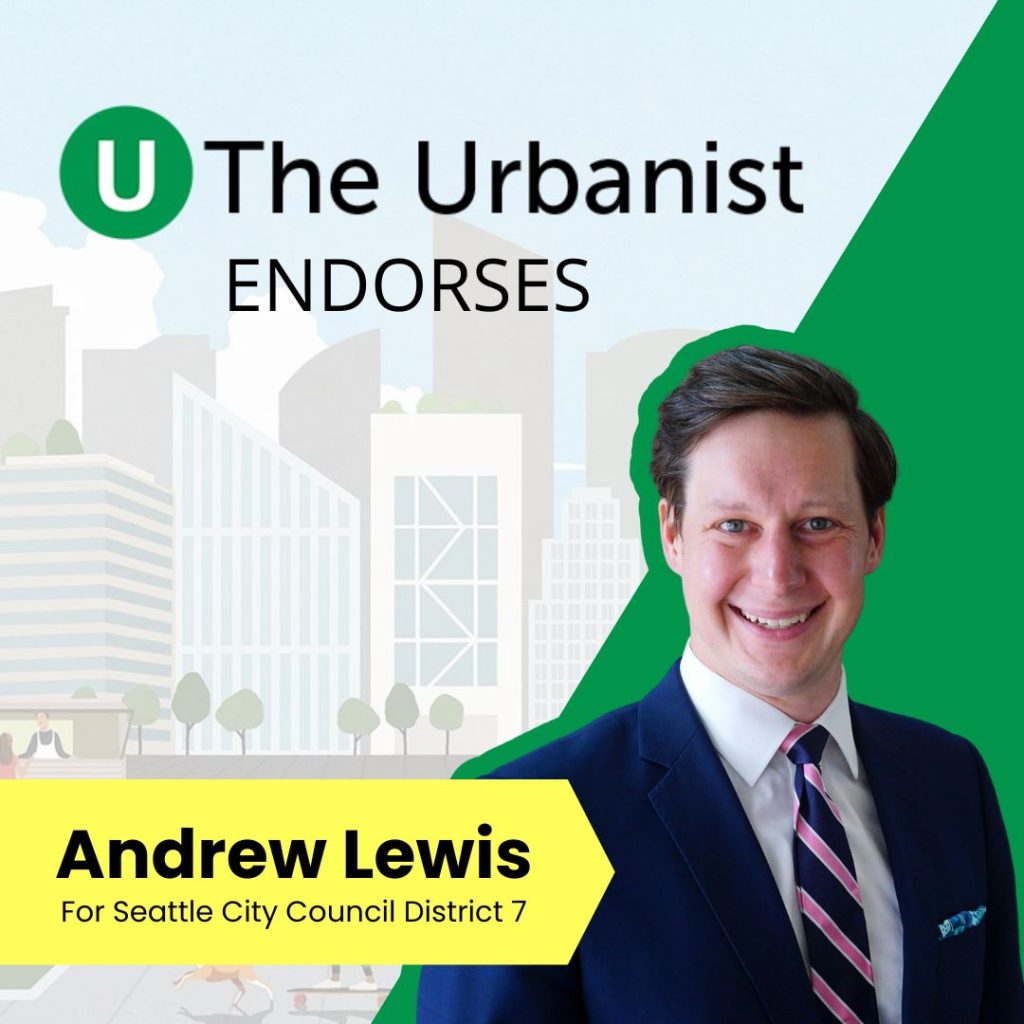 Andrew Lewis smiles, a White man in a suit.