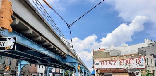 Steel girders painted blue support the elevated rail line in Philly's Fishtown neighborhood.
