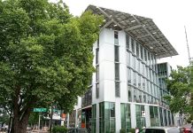 Ten Years Later, the Bullitt Center Still Sets the Standard for Green Office Buildings Street view of the white six-story Bullitt Center.