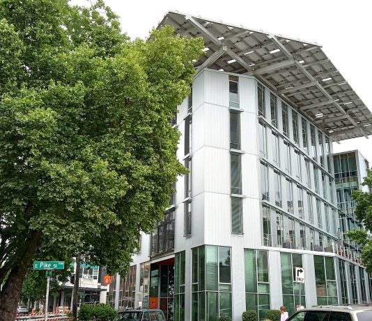 Ten Years Later, the Bullitt Center Still Sets the Standard for Green Office Buildings Street view of the white six-story Bullitt Center.