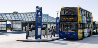 Sound Transit Selects Private Bus Operator for Stride BRT Network A double decker bus is rendered in Stride livery sitting at a bus station.