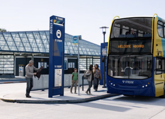 Sound Transit Selects Private Bus Operator for Stride BRT Network A double decker bus is rendered in Stride livery sitting at a bus station.