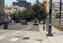 ‘Even Better Bike Lane’ Program Slowly Improves Upon Oft-Trampled Plastic Posts Looking down Western Avenue at a white car in the bike lane.