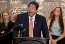 Harrell’s 2024 Budget Leaves Big Questions on Safety and Looming Shortfall Mayor Harrell at a podium with people behind him. He is talking about funding programs for the homeless.