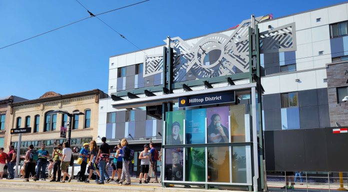 Becoming a ’15-Minute City’ Could Be Within Reach for Tacoma Sunny opening day of the T-Line with people waiting for a streetcar to arrive.