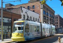 Harrell’s Transportation Budget Focuses on Downtown But Leaves Out the Streetcar Yellow front of a streetcar passing in front of brick buildings.