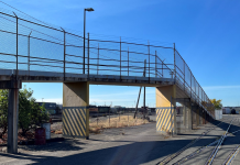 Port of Seattle To Upgrade Interbay Bike Trail, Removing Major Pinch Points Fenced ramp to a multi-use path bridge over the Interbay railroad tracks.