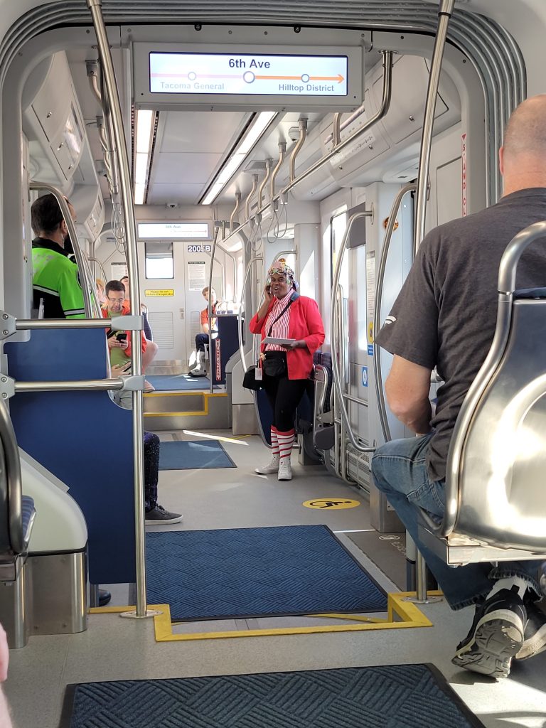 A Sound Transit staff is on a streetcar as a tour guide on opening day of the T-Line.