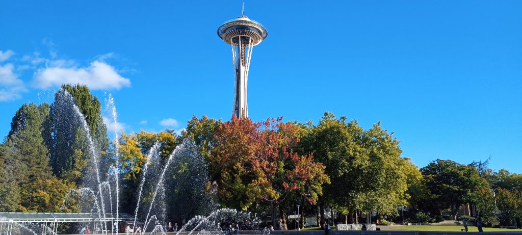 Trees in fall colors with the International Fountain and the Space Needle.