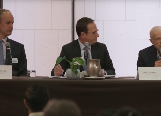 Bellevue Council Hopefuls Square Off at Forums on Safety, Environment, and Downtown Men in suits at a table with a white background.