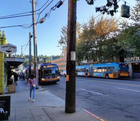 Metro Seeing Early Signs of Labor Rebound and Ridership Momentum Two northbound buses line up outside Lucky Pho on Fremont Avenue with another southbound Route 62 across the street.