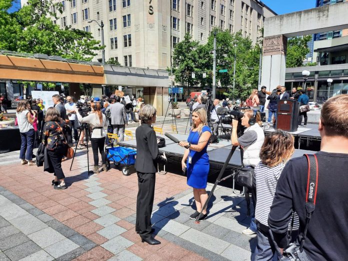 Councilmember Nelson talked a TV reporter at a Westlake Park press conference in summer 2023.